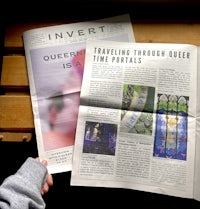 a person holding a newspaper with the words invert traveling time portals