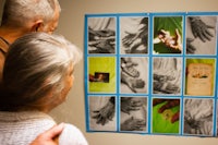 a man and a woman looking at pictures on a wall